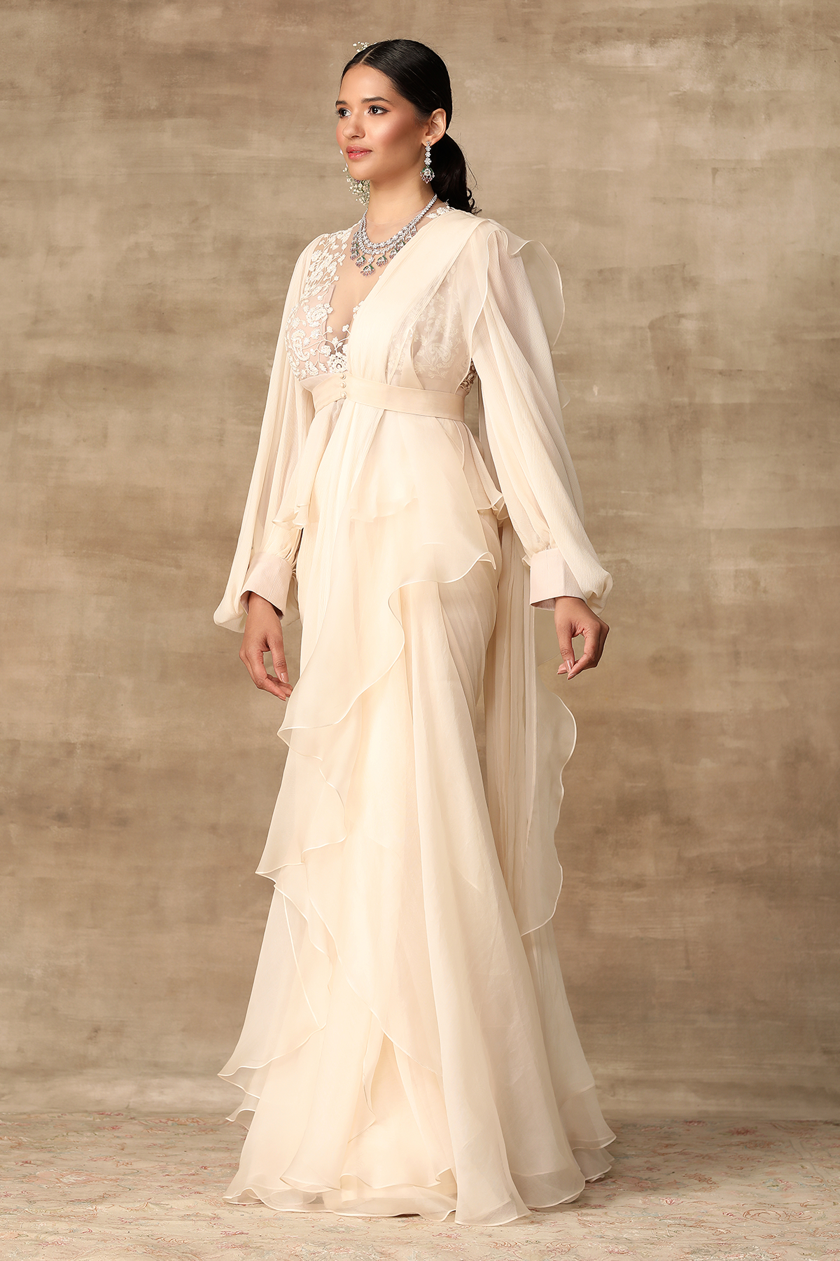 RIDHI-MEHRA-Ivory embroidered net-chiffon peplum with exaggerated sleeves paired with chiffon-organza draped ruffle saree.